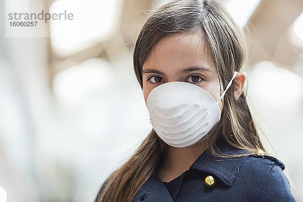 Junges Mädchen steht mit einer Schutzmaske zum Schutz vor COVID-19 während der Coronavirus-Weltpandemie; Toronto  Ontario  Kanada