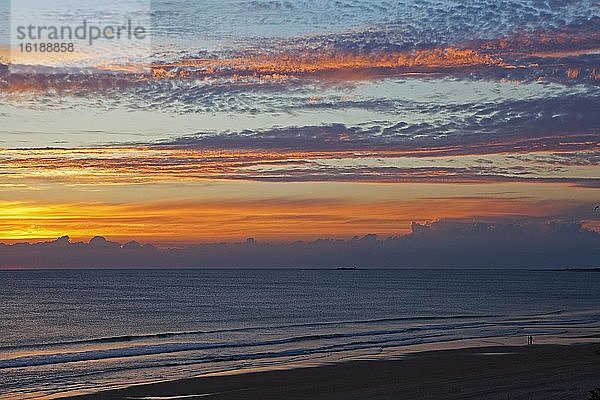 Ein Paar spaziert bei Sonnenuntergang am Barrosa Strand entlang  Provinz Cádiz  Spanien  Europa