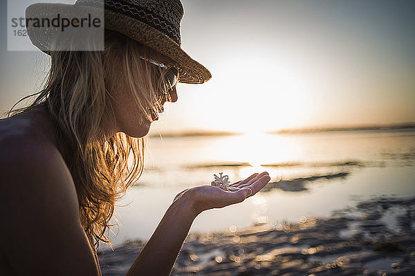 Frau mit Korallenstück in der Hand  Gili Air  Indonesien