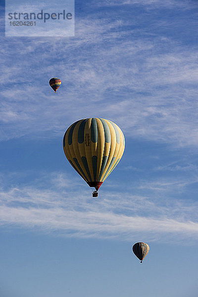 Drei Heißluftballons schweben gegen den blauen Himmel  Goreme National Park  Kappadokien  Anatolien  Türkei
