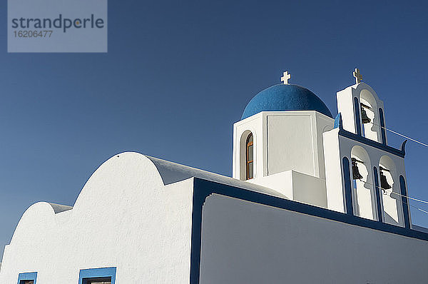 Blick auf eine weiß getünchte Kirche und blauen Himmel  Oia  Santorin  Griechenland
