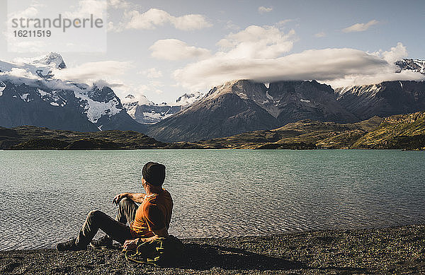Mann sitzt und bewundert die Aussicht auf den Pehoe-See im Torres Del Paine Nationalpark  Chile Patagonien  Südamerika