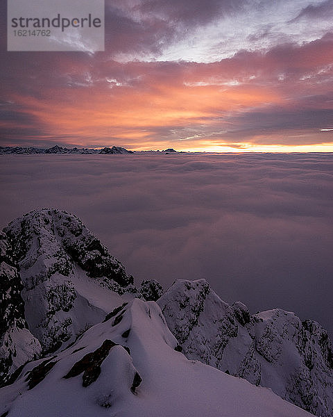 Schneebedeckter Gipfel des Aggensteins bei stimmungsvollem Sonnenuntergang