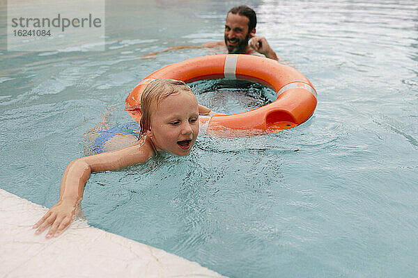 Junge mit Vater im Schwimmbad