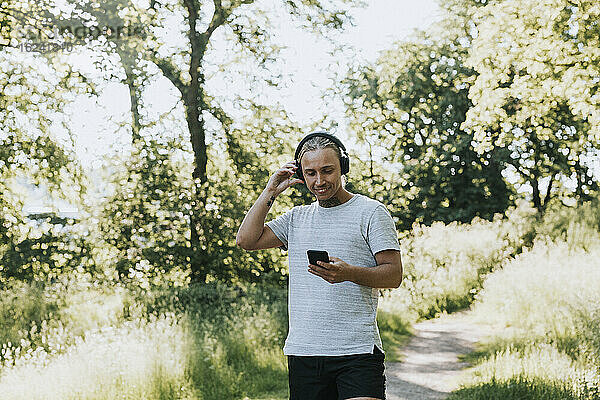 Lächelnd das Telefon überprüfen