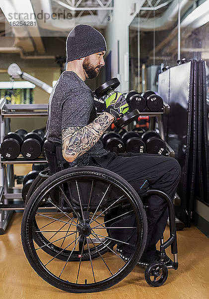 Ein querschnittsgelähmter Mann beim Training mit freien Gewichten vor einem Spiegel im Freizeitzentrum: Sherwood Park  Alberta  Kanada