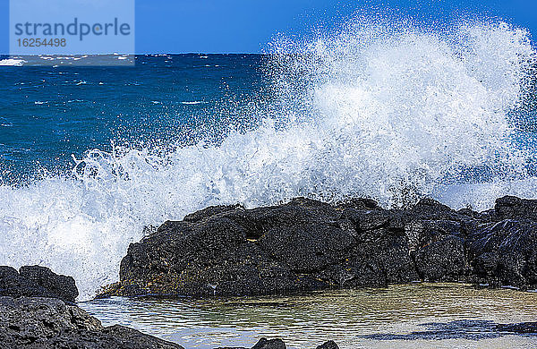 Krachende und plätschernde Wellen auf Lavagestein entlang der Küste der Kaupo-Bucht; Oahu  Hawaii  Vereinigte Staaten von Amerika