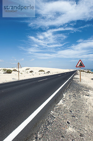 Spanien  Fuerteventura  Corralejo  Parque Natural de Corralejo  Blick auf leere Straße und Straßenschild