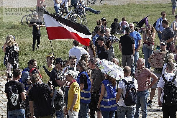 Demo gegen Corona-Regeln auf den Rheinwiesen  Mann mit verbotener Reichskriegsflagge  umringt von Menschen  Düsseldorf  Nordrhein-Westfalen  Deutschland  Europa