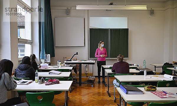Lehrerin mit Mundschutzmaske im Präsenzunterricht  Fenster geschlossen  Corona-Krise  Stuttgart  Baden-Württemberg  Deutschland  Europa