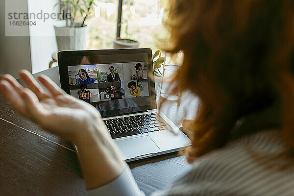 Frau benutzt Laptop während eines Videogesprächs zu Hause