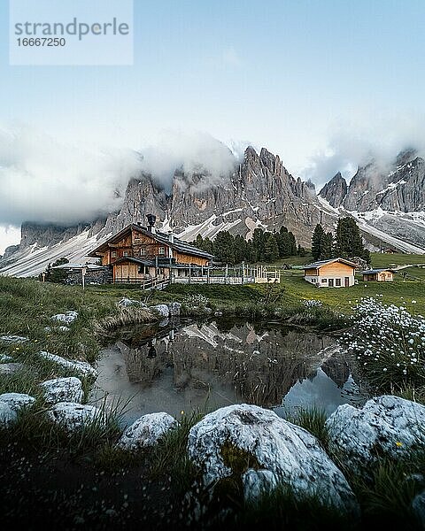 Spiegelung von dem Furchetta Berg und der Geisler Alm Hütte in einem Tümpel bei der Geisler Alm  Sankt Magdalena  Südtirol  Italien  Europa