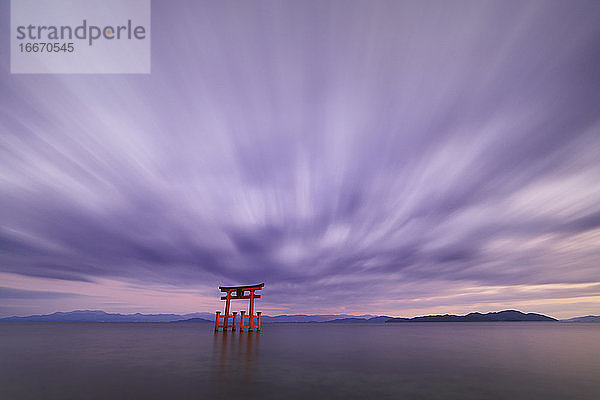 Langzeitbelichtung des Shirahige-Schreins Torii-Tor bei Sonnenuntergang am Biwa-See  Präfektur Shiga  Japan