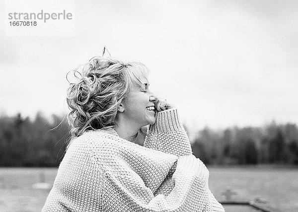 Porträt einer lächelnden  glücklich aussehenden Frau  die draußen frische Luft atmet