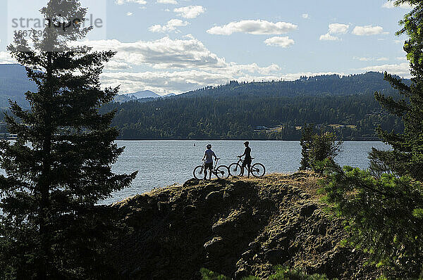 Ein junges Paar genießt den Blick auf den Columbia River beim Radfahren in OR.