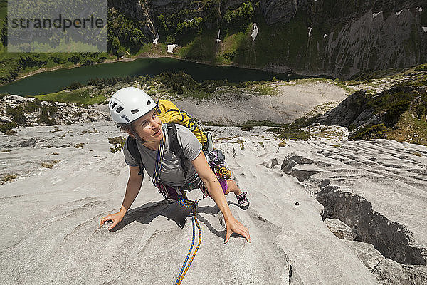 Frau klettert auf Kalksteinfelsen im Alpstein  Appenzell  Schweiz