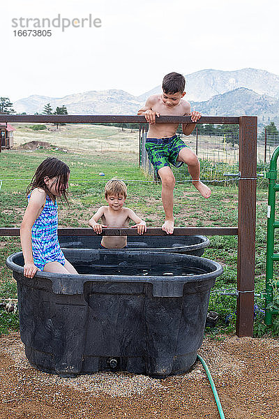 Colorado-Kinder spielen in der Pferdetränke