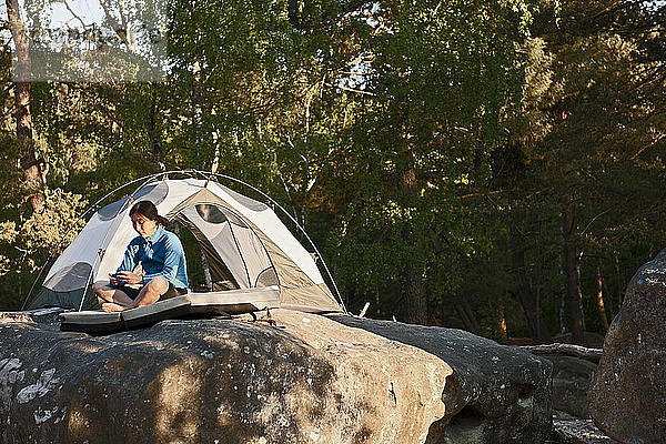 Reife Frau beim Zelten im Wald von Fontainebleau in der Nähe von Paris