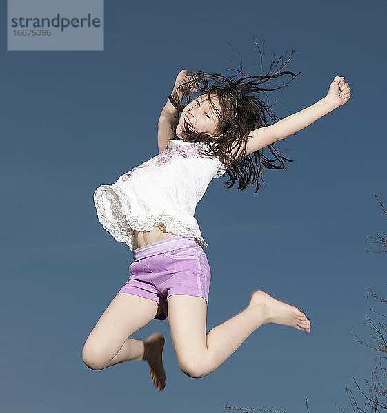 junges Mädchen springt auf einem Trampolin in Woking - England