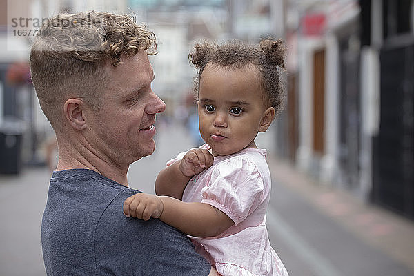 Ein Vater hält seine kleine Tochter