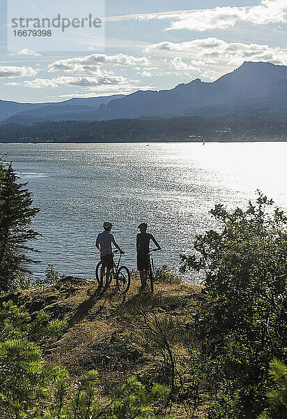 Ein junges Paar genießt den Blick auf den Columbia River beim Radfahren in OR.