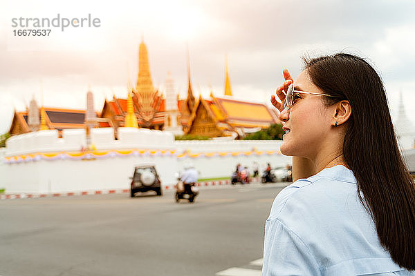 Junge Frau auf dem Weg zum Großen Palast und Wat Phra Keaw in Sunse