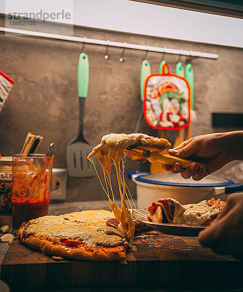 Selektiver Fokus auf italienische Pizza  Gewürze in Mühlen  Flasche und Glas Wein auf Holztischplatte