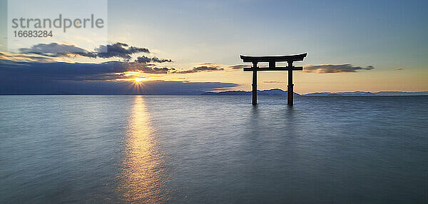 Langzeitbelichtung des Shirahige-Schreins Torii-Tor bei Sonnenaufgang  Biwa-See  Präfektur Shiga  Japan