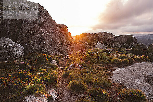 Wanderweg bei Sonnenuntergang inmitten von Felsen in den norwegischen Bergen