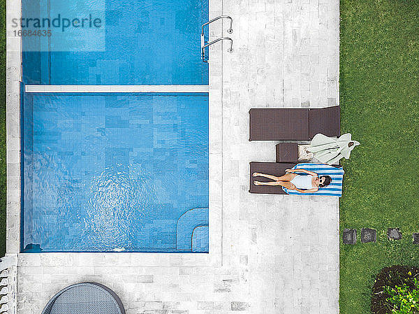 Luftaufnahme einer attraktiven Frau in der Nähe des Pools im Resort