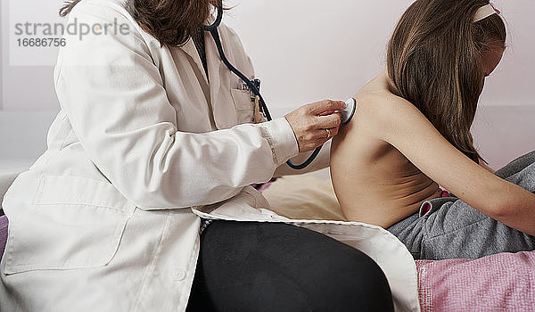 Kinderarzt untersucht kleines Mädchen mit Stethoskop. Kind  ca