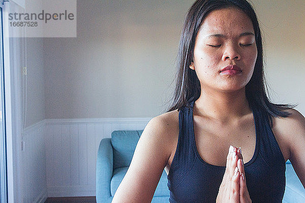 Konzentrierte junge Frau beim Meditieren und Yoga üben