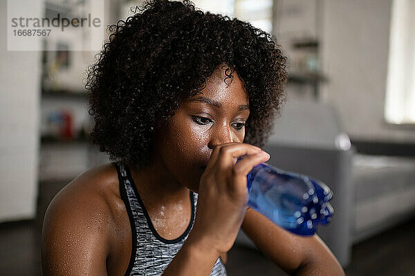 Afroamerikanische Sportlerin trinkt Wasser