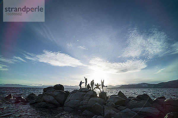 Silhouette einer Gruppe von Freunden in albernen Posen am Strand