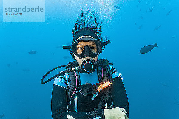 Taucher schaut in die Kamera am Great Barrier Reef
