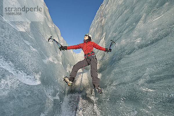 Frau beim Klettern auf dem Fjallsjökull-Gletscher in Island