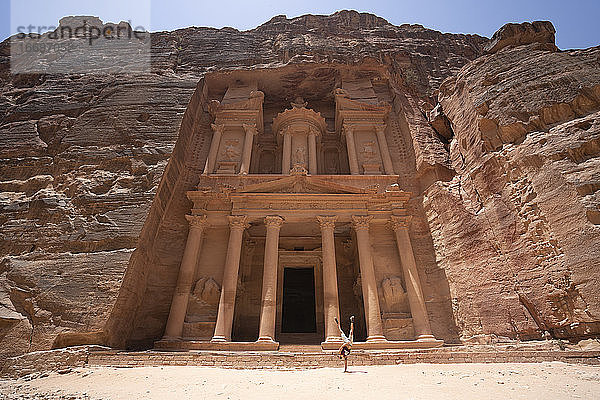 Ein Mann macht einen Handstand in der Nähe des Treasury Monuments in Petra  Jordanien sieben Wunder