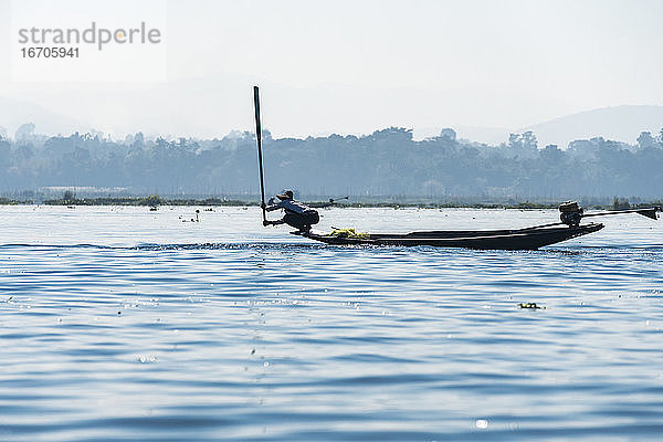 Fischer fängt mit einem Paddel Fische vom Boot aus  Inle-See  Nyaungshwe  Myanmar