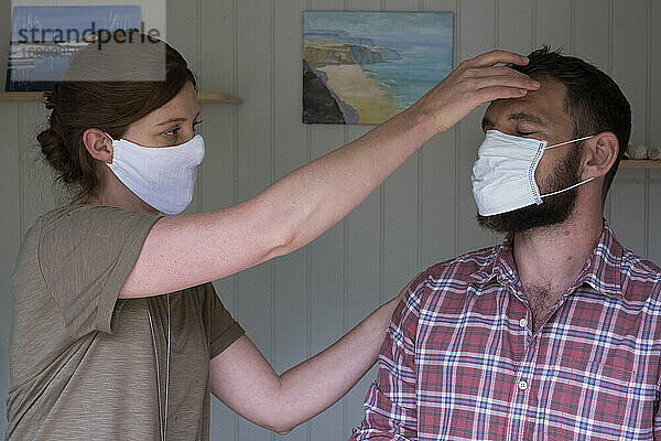 Therapeut und Klient mit Gesichtsmasken  in einer alternativen Therapiesitzung.
