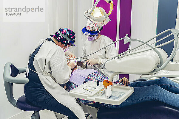Ein Team von Zahnärzten operiert einen Patienten
