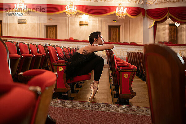 Ballerina sitzt im leeren Zuschauerraum