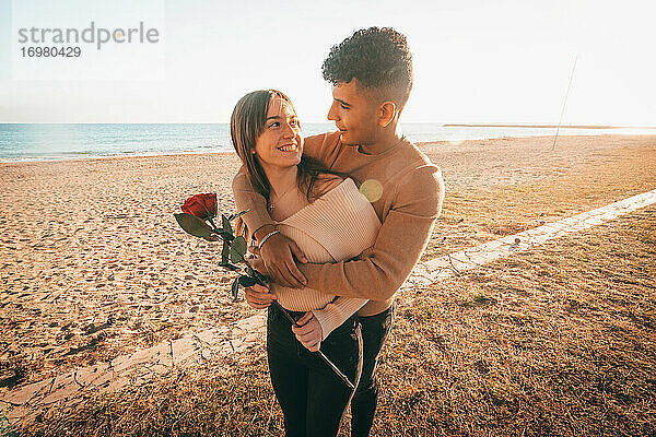 Lovely Shot Of A Young Couple In Love Hugging On The Beach