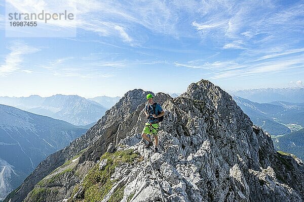 Bergsteiger auf einem Grat an einem gesicherten Klettersteig  Mittenwalder Höhenweg  Karwendelgebirge  Mittenwald  Bayern  Deutschland  Europa