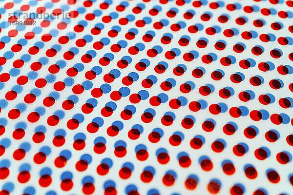 3D rote und blaue Punkte Muster überlappend auf weißem Hintergrund