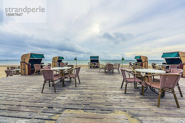 Leere Strandpromenade mit Stühlen und Tischen