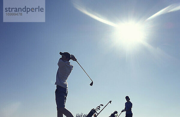 Freunde spielen Golf klaren blauen Himmel während sonnigen Tag