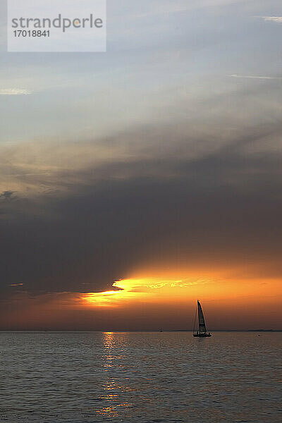 Silhouette eines Segelboots auf dem Bodensee bei stimmungsvollem Sonnenuntergang