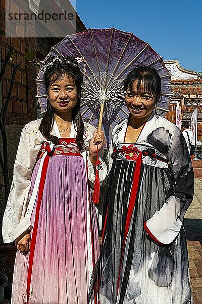 Einheimisch gekleidete Frauen bei traditionellen Häusern im Minnan-Stil  Shanhou Folk Culture Village  Insel Kinmen  Taiwan  Asien