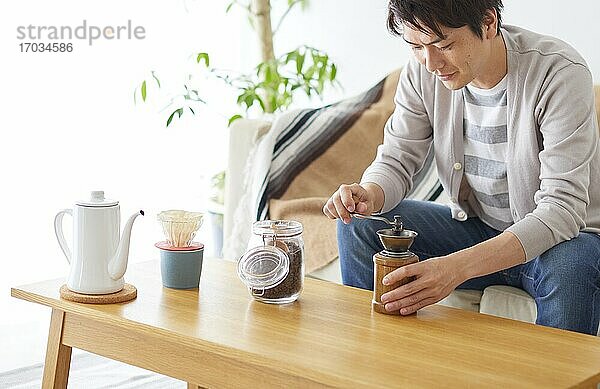 Japanischer Mann kocht zu Hause Kaffee