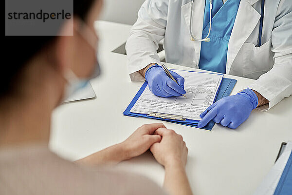 Medical professional prescribing new treatment to patient